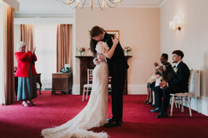 Bride and groom embrace after marriage at Newport Registry Office