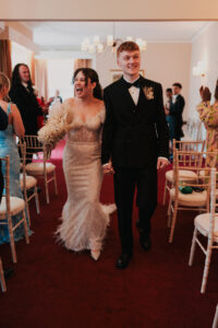 Bride and groom exit down aisle of Newport Registry Office