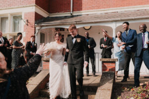 Wedding guests throwing confetti over bride and groom at Newport Registry Office