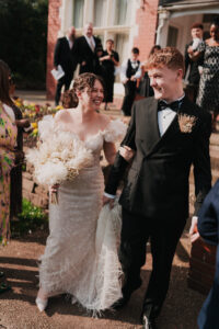 Happy bride and groom smiling with wedding guests at Newport Registry Office