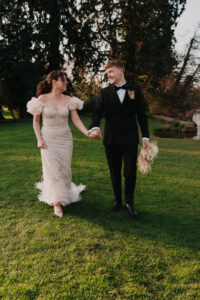 Bride and groom walking together through the grounds, candid shot
