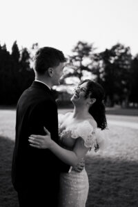 Bride and groom laughing together at Tredegar House, black-and-white