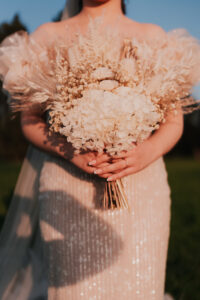 Detail shot of the bride's wedding ring and bouquet