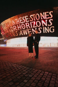 Portrait of bride and groom in front of the Wales Millennium Centre