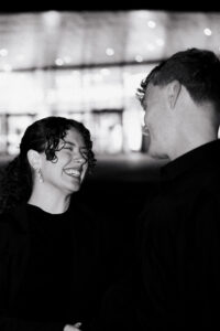 Black-and-white candid moment in Cardiff Bay with bride and groom
