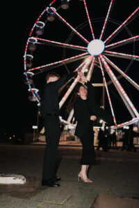 Portrait of bride and groom dancing in Cardiff Bay at night