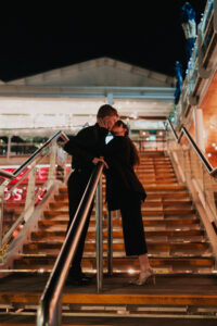 Portrait of bride and groom kissing on a stair case in Cardiff Bay