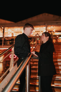 Bride and groom smiling at each other, candid moment