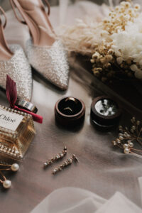 Detail shot of the wedding bands among other attire