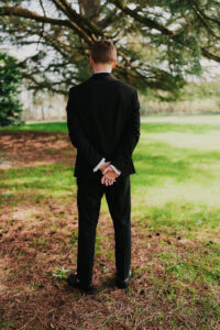 Portrait of groom waiting for first look with bride