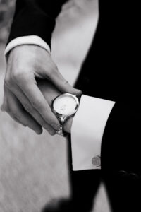Black-and-white close up of groom's watch, detail shot