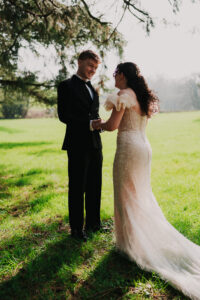 Smiling groom talks with bride, candid