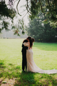 Bride and groom exchange hug