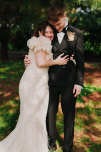 Candid portrait of bride and groom embracing in hug