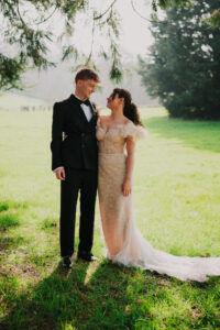Formal portrait of bride and groom hugging each other side by side