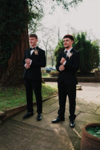 Groom and wedding guest candid pose