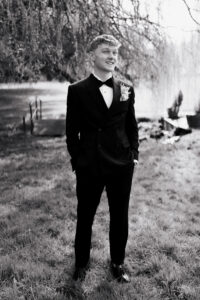 Black-and-white portrait of groom in tux in Wyndham Cwrt Bleddyn