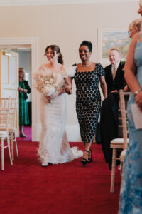 Bride walks down the aisle with family member