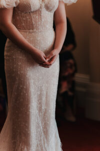 Close-up of bride's hands at the end of the aisle