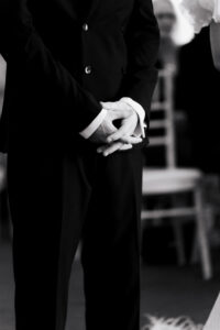 Black-and-white close up of groom's hands
