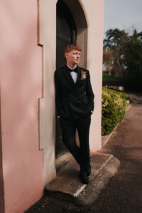Formal pose of groom in front of the Ramada Resort