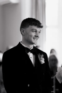 Black-and-white portrait of groom during wedding ceremony
