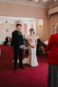 Bride and groom smiling at each other during ceremony
