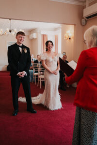Candid laughter during wedding ceremony at Newport Registry Office