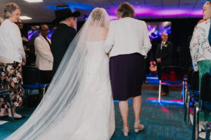Father and mother of the bride walking her down the aisle