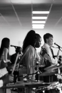 Backing singer with mic leading worship