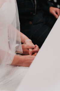Close up of bride and groom's hands during the wedding registry