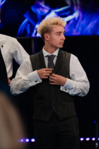 Wedding guest adjusting tie before ceremony