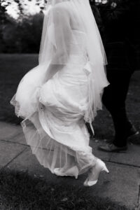 Bride carrying her wedding dress