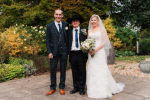 Wedding portrait with groom, father of the bride, and the bride