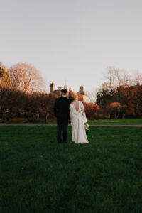Bride leaning on grooms shoulder during golden hour in Bute Park