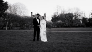 Landscape photo of candid moment between bride and groom, black-and-white