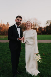 Bride and groom smiling in Bute Park