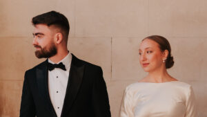 Portrait of bride and groom looking away from the camera