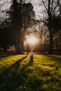 Bride and groom dancing in as the sun sets