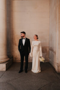 Wide shot of the bride and groom looking away from the camera