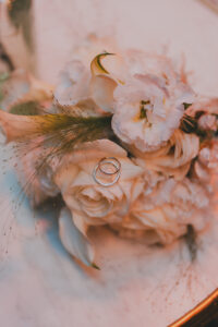 Close up shot of the wedding bands in the bride's bouquet