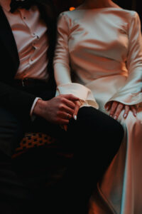 Detail shot of the bride and grooms wedding attire, candid moment