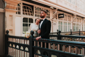 Bride and groom leaning on each other