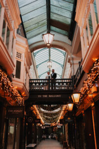 Wide shot of Morgan Arcade with bride and groom standing on a balcony