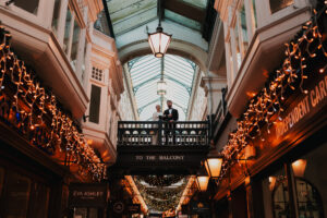 Wide, landscape portrait of bride and groom in Cardiff Arcade