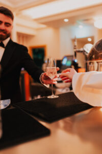 Groom passing the bride her drink