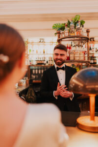 Groom feeling his new wedding band and smiling