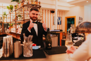 Portrait of groom giving two thumbs up and smiling, candid moment