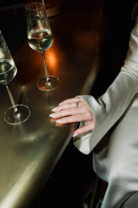 Close-up of brides hands on the bar, direct flash
