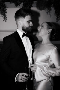 Black-and-white portrait of bride and groom with direct flash